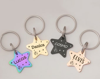 May include: Four star-shaped keychains with different colored finishes. The keychains are engraved with the names "Lucas", "Danica", "Cosmo", and "Elvis".
