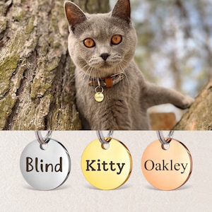 May include: Three round pet ID tags with different names engraved on them. The tags are silver, gold, and rose gold. The names are "Blind", "Kitty", and "Oakley".