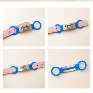 K&ouml;nnte beinhalten: Ein pinkfarbenes Lederhundekragen mit einem blauen Metalletikett, auf dem "Cookie Microchipped 1234567890" steht. Das Etikett ist mit zwei blauen Metallringen am Halsband befestigt.