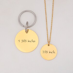 May include: Gold-toned necklace and keychain set with round pendants. The necklace pendant measures 7/8 inch and the keychain pendant measures 1 3/8 inches.