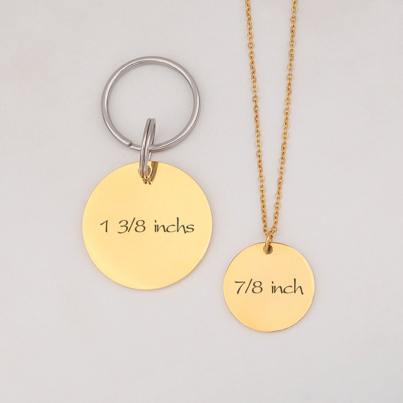 May include: Gold-toned necklace and keychain set with round pendants. The necklace pendant measures 7/8 inch and the keychain pendant measures 1 3/8 inches.