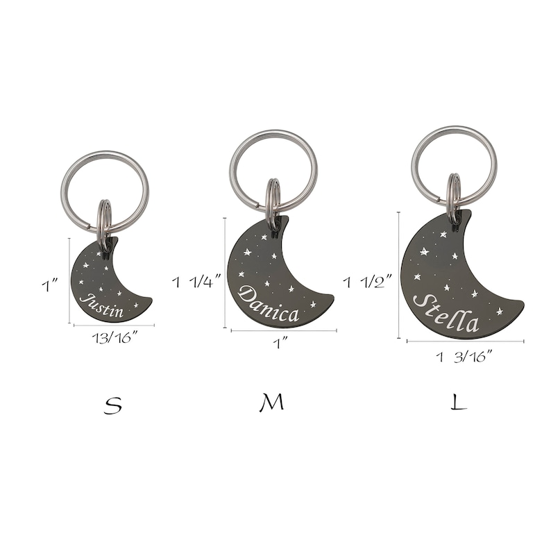 May include: Three silver crescent moon pet ID tags with engraved names "Justin", "Danica", and "Stella". The tags are available in three sizes: small (1 inch), medium (1 1/4 inches), and large (1 1/2 inches).