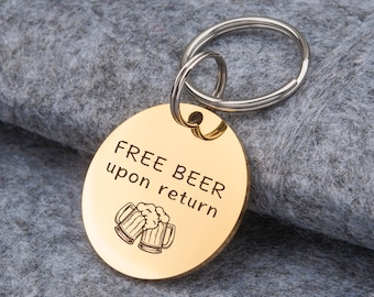 May include: Gold-colored metal keychain with a round tag that says "FREE BEER upon return" with a graphic of two beer mugs.