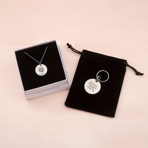 May include: A silver necklace and keychain with a round tag featuring a cat's face and the name "Lucky". The keychain also includes the text "300 Canada Dr. City, State 12345 123-456-7890".