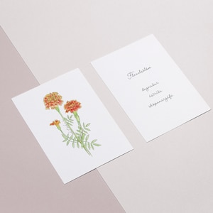 May include: Two cards, one with a watercolor illustration of orange marigolds and the other with the text "Flower list" and a list of flower names: "Dogwood", "Petunia", "Snapdragon".