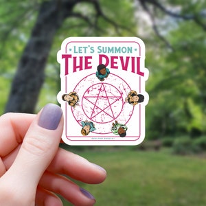 May include: A sticker with a pentagram and five children in a circle around it. The sticker says "Let's Summon The Devil" and "Fun for ages 8+."