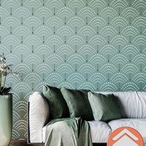 May include: A white couch with green throw pillows and a green throw blanket in front of a wall with a teal and white geometric pattern. The pattern is made up of small circles and diamonds. The text "STENCILOGY" is visible in the lower right corner of the image.