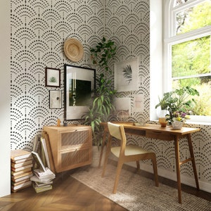 May include: A home office with a wooden desk and chair, a side table with books and a woven basket, and a wall with a black and white geometric pattern wallpaper.