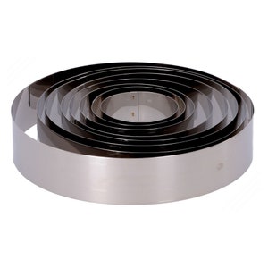 May include: A set of round, silver cake rings, nested together. The rings are made of stainless steel and have a smooth, polished finish.
