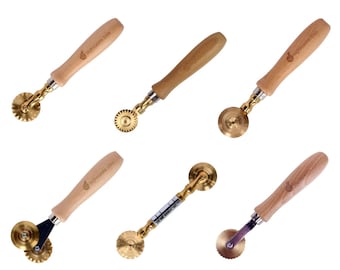 May include: Five different pastry cutters with wooden handles and brass wheels. The wheels have different patterns of teeth.