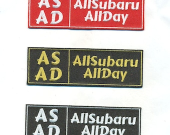 May include: Three embroidered patches with the text "AS AD" and "AllSubaru AllDay". The first patch is red with white text. The second patch is black with gold text. The third patch is black with white text.