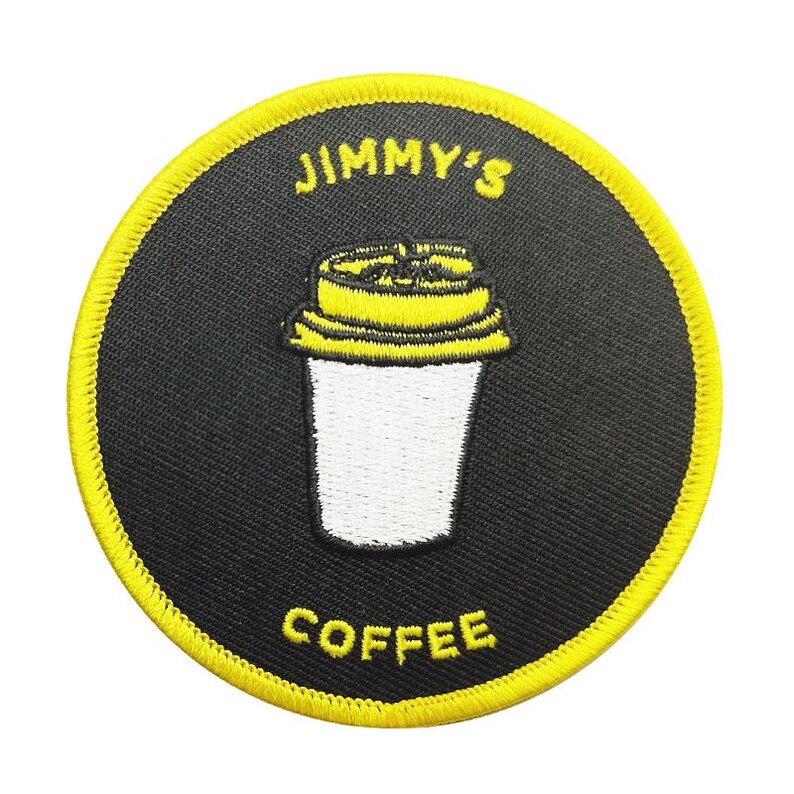 May include: A yellow and black embroidered patch with the text "JIMMY'S COFFEE" and a white coffee cup with a yellow lid.