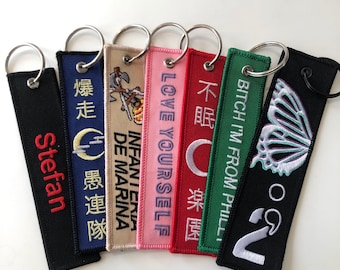 Llaveros bordados al por mayor, etiquetas de vuelo personalizadas, envío gratuito, tiempo de respuesta rápido, muestras gratuitas antes de la producción.