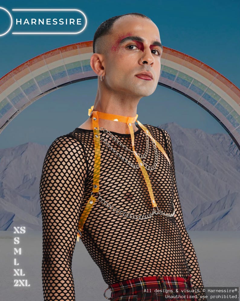 May include: A person wearing a black fishnet top with an orange harness and silver chain accents. The harness includes a choker and straps. The background features a rainbow and the text "HARNESSIRE".