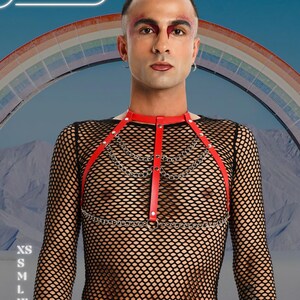 May include: Red leather harness with silver chain detailing. The harness is worn over a black fishnet top. The image includes the text "HARNESSIRE" and size options: XS, S, M, L, XL, and 2XL. A rainbow is in the background.