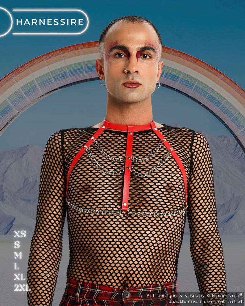 May include: Red leather harness with silver chain detailing. The harness is worn over a black fishnet top. The image includes the text "HARNESSIRE" and size options: XS, S, M, L, XL, and 2XL. A rainbow is in the background.