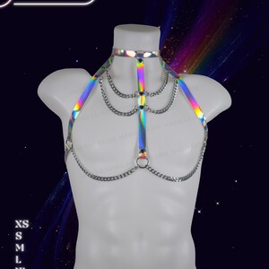 Genderless holographic harness displayed on a male mannequin with reflective rainbow tones and adjustable straps.