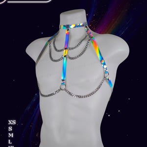 Genderless holographic harness displayed on a male mannequin with reflective rainbow tones and adjustable straps.