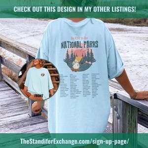 May include: Light blue t-shirt with a graphic design of a campfire in a forest with the text "Be Kind to Our National Parks" and a list of all the national parks in the United States.
