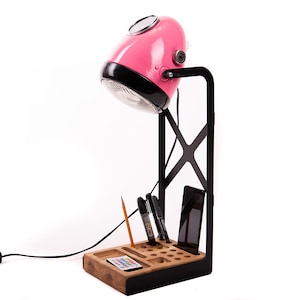 Unique pink lamp with original motorcycle headlight on metal base, wooden desk organizer in the base, retro motorcycle headlight, table lamp