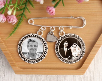 May include: A silver brooch with two round photo charms and a heart charm. The photo charms feature black and white photos of a couple and a man.