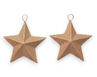 May include: Two gold-coloured metal star ornaments with a loop at the top for hanging.