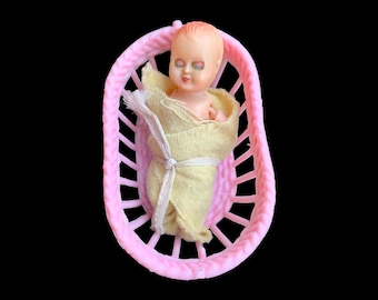 1950&#39;s  Celluloid Baby in Pink plastic Basket