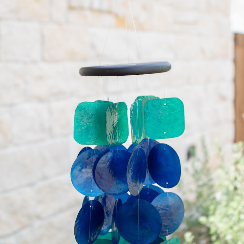 Coastal Wind Chime Garden Decoration Beach House Accent Piece Capiz Shell Blue Green Windchime Outdoor Patio Decoration Melodic Mobile Sunlight Catching Peacock Design Handcrafted Chimes Nautical Home Styling Ocean Inspired Art Musical