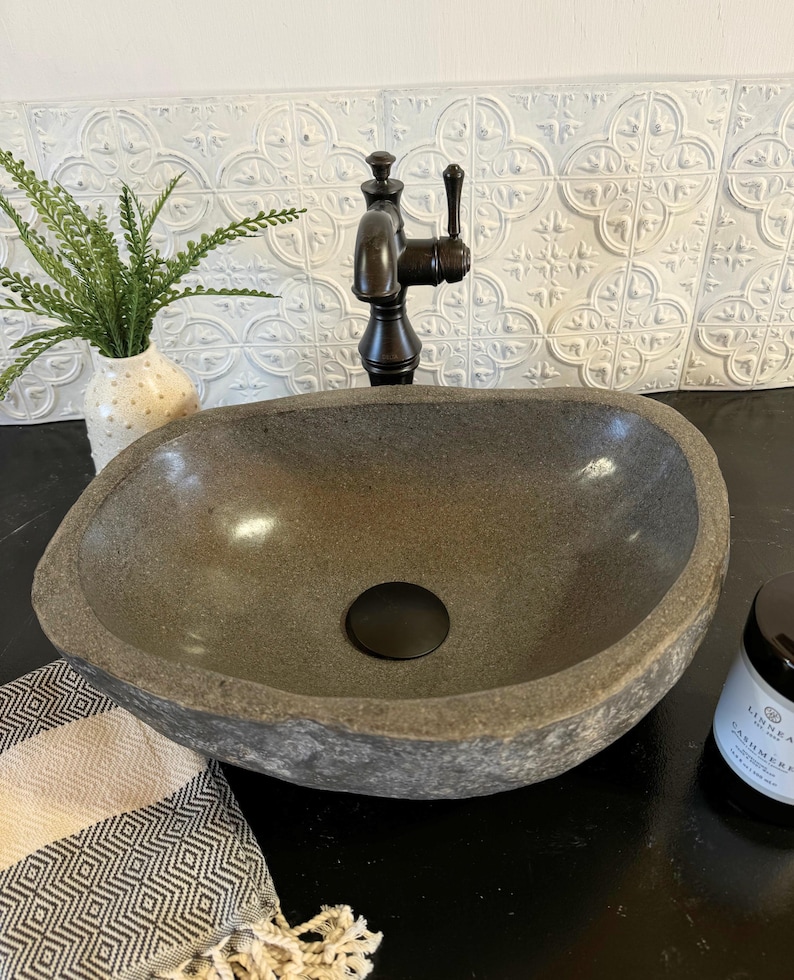 Earthy Boho Style Stone Sink Natural River Rock Basin Bali Inspired Design Bathroom Vanity Fixture Handcrafted Vessel Bowl Java Island Origin Unique Bathroom Feature One Of A Kind Creation Natural Material Construction Organic Home Element