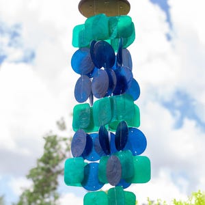 Blue Green Wind Chime Capiz Shell Material Coastal Design Mobile Sunlight Catching Decoration Garden Patio Accent Handcrafted Musical Piece Peacock Color Pattern Beach House Enhancement Outdoor Hanging Decoration Melodic Sound Element