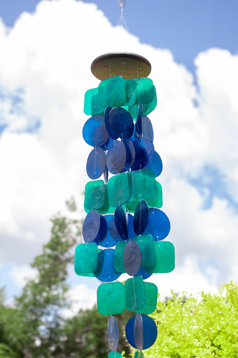 Blue Green Wind Chime Capiz Shell Material Coastal Design Mobile Sunlight Catching Decoration Garden Patio Accent Handcrafted Musical Piece Peacock Color Pattern Beach House Enhancement Outdoor Hanging Decoration Melodic Sound Element