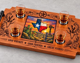 May include: A rectangular wooden serving tray with black metal handles, four glass whiskey tumblers, and a central tile featuring a Texas map, cactus, and windmill. The wood is engraved with the text GOOD WHISKEY GOOD FRIENDS GREAT STORIES.