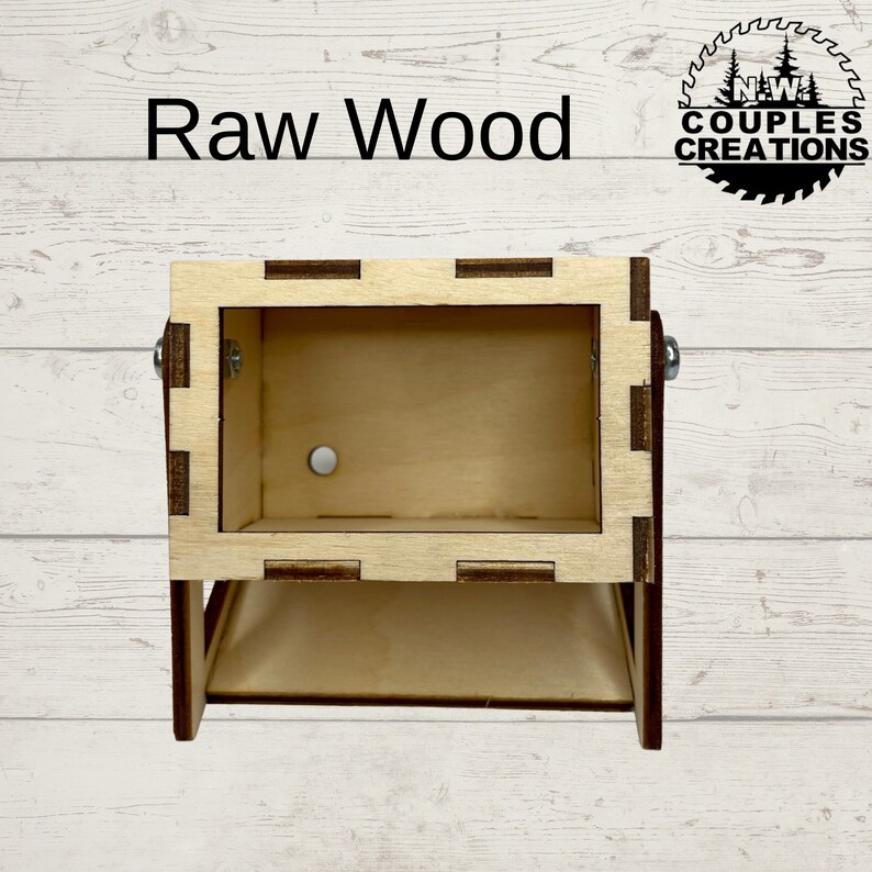 May include: A small wooden box with a hinged lid and a cutout window. The box is made of unfinished wood and has a natural wood color. The box is labeled "Raw Wood".