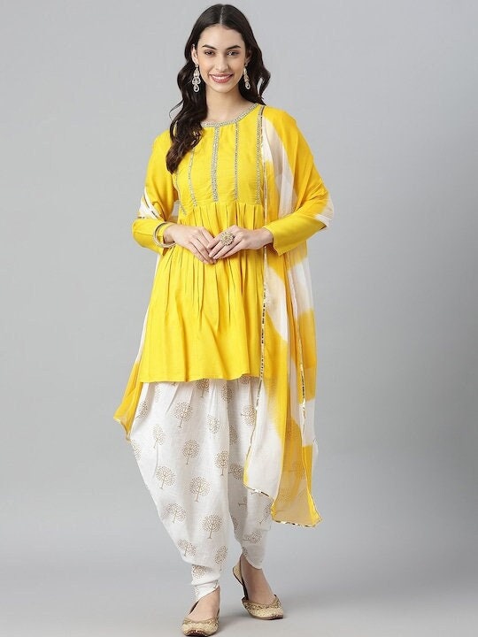 Buy Canary Yellow Dhoti Suit With High Low Hemline And Embellished  Geometric Buttis Online - Kalki Fashion
