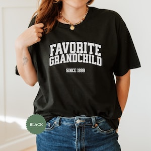 May include: Black t-shirt with white text that reads "Favorite Grandchild Since 1999".