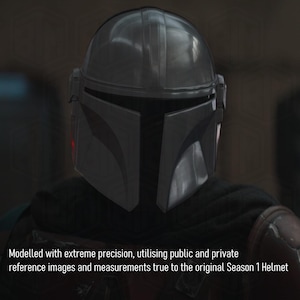 May include: A close-up of a dark gray Mandalorian helmet. The helmet has a sleek, metallic appearance with a T-shaped visor and a rounded top. The text at the bottom reads: "Modelled with extreme precision, utilising public and private reference images and measurements true to the original Season 1 Helmet."