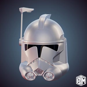 May include: A silver-colored Clone Trooper helmet with a visor, a vertical antenna, and two circular details on the lower front. The helmet has a smooth, reflective surface and is set against a dark blue background.