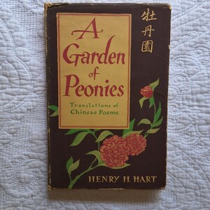May include: A vintage book titled "A Garden of Peonies" with the subtitle "Translations of Chinese Poems." The cover is brown with a gold rectangular panel featuring the title in maroon. Peony illustrations and Chinese characters are also present.