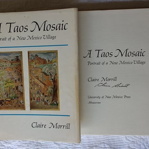 May include: A book titled "A Taos Mosaic: Portrait of a New Mexico Village" by Claire Morrill. The book cover features two illustrations of a village scene. The book is published by the University of New Mexico Press.