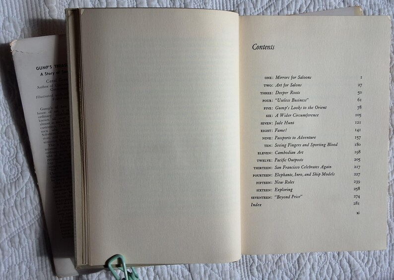 May include: Open book with the title "Gump's Treasure" visible on the left page. The right page displays a table of contents with chapter titles. A green paper clip holds the pages together.