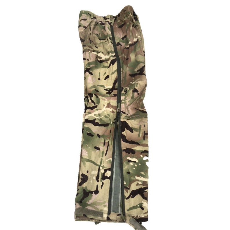 May include: Camouflage-patterned waterproof pants with a zipper down the side seam.