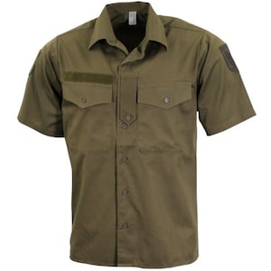 May include: A green short-sleeved button-down shirt with two large pockets on the front and a small patch on the right sleeve.