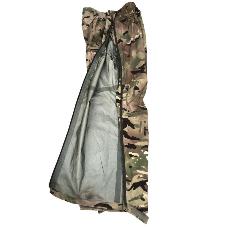 May include: Camouflage waterproof pants with a zipper down the front and a gray lining. The pants are made of a durable material and are designed for outdoor activities.