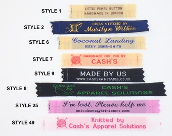 May include: A collection of 10 different styles of woven fabric labels with various text and designs. The labels are all black, white, pink, or cream in color. The text on the labels includes "Little Pearl Button", "Handmade in London", "Cross Stitched by Marilyn Wilkie", "Coconut Landing", "Becky Usher-Smith", "Handmade for you by CASH'S", "Made by Us", "www.cashsnahetapes.co.uk", "Designed by", "CASH'S Apparel Solutions", "I'm lost. Please help me", "imisshome@btinternet.com", "Knitted by Cash's Apparel Solutions".