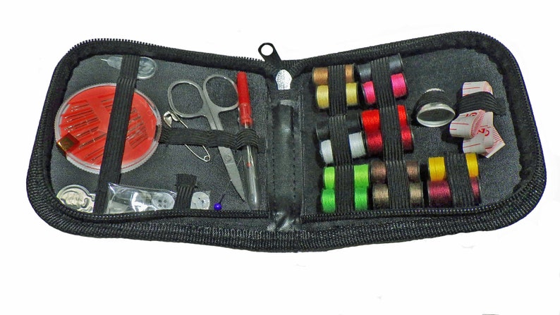 May include: A black zippered travel sewing kit with a variety of sewing supplies, including needles, thread, buttons, a thimble, scissors, and a tape measure.