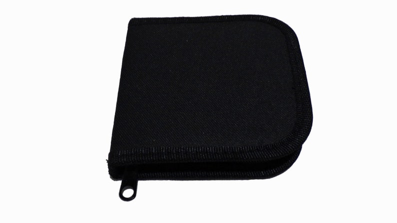 May include: A black zippered case with a fabric exterior and a black zipper pull.