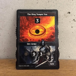 El anillo te tienta y ficha del ejército orco con pantalla numérica – Magic the Gathering