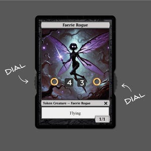 May include: A black and white card with a purple and black fairy illustration. The card text reads "Faerie Rogue" and "Token Creature - Faerie Rogue". The card has a power and toughness of 1/1 and the ability "Flying".