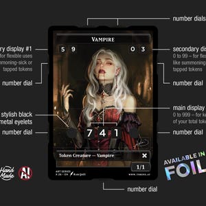 May include: A black and red Vampire token card with a portrait of a woman with white hair and blood dripping from her mouth. The card has multiple number dials and displays for tracking game stats. The text "AVAILABLE IN FOIL" is visible.