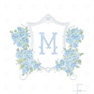 May include: A light blue monogram letter "M" is centered within a decorative shield, surrounded by watercolor-style blue hydrangea flowers. The design is set against a white background with a subtle pattern. The text "THE ELLIS HOUSE" is at the bottom.